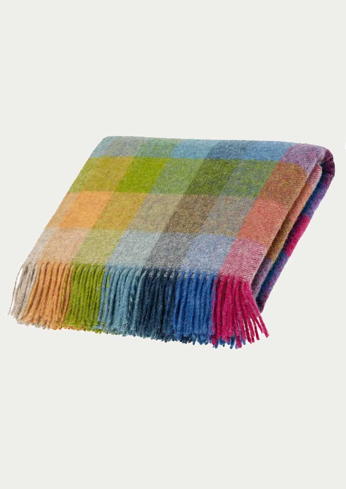 Multicolored checkered blanket with fringes on a light gray background