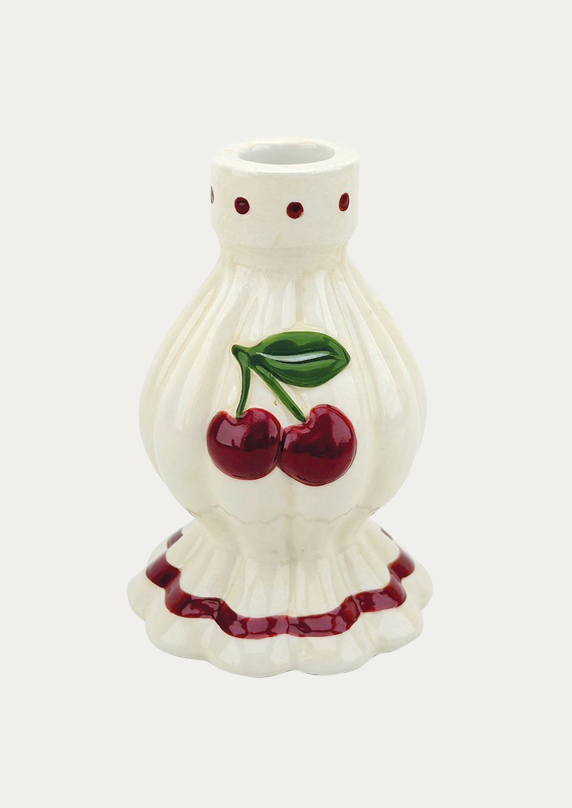 A white ceramic taper holder with a pair of red cherries on the front.