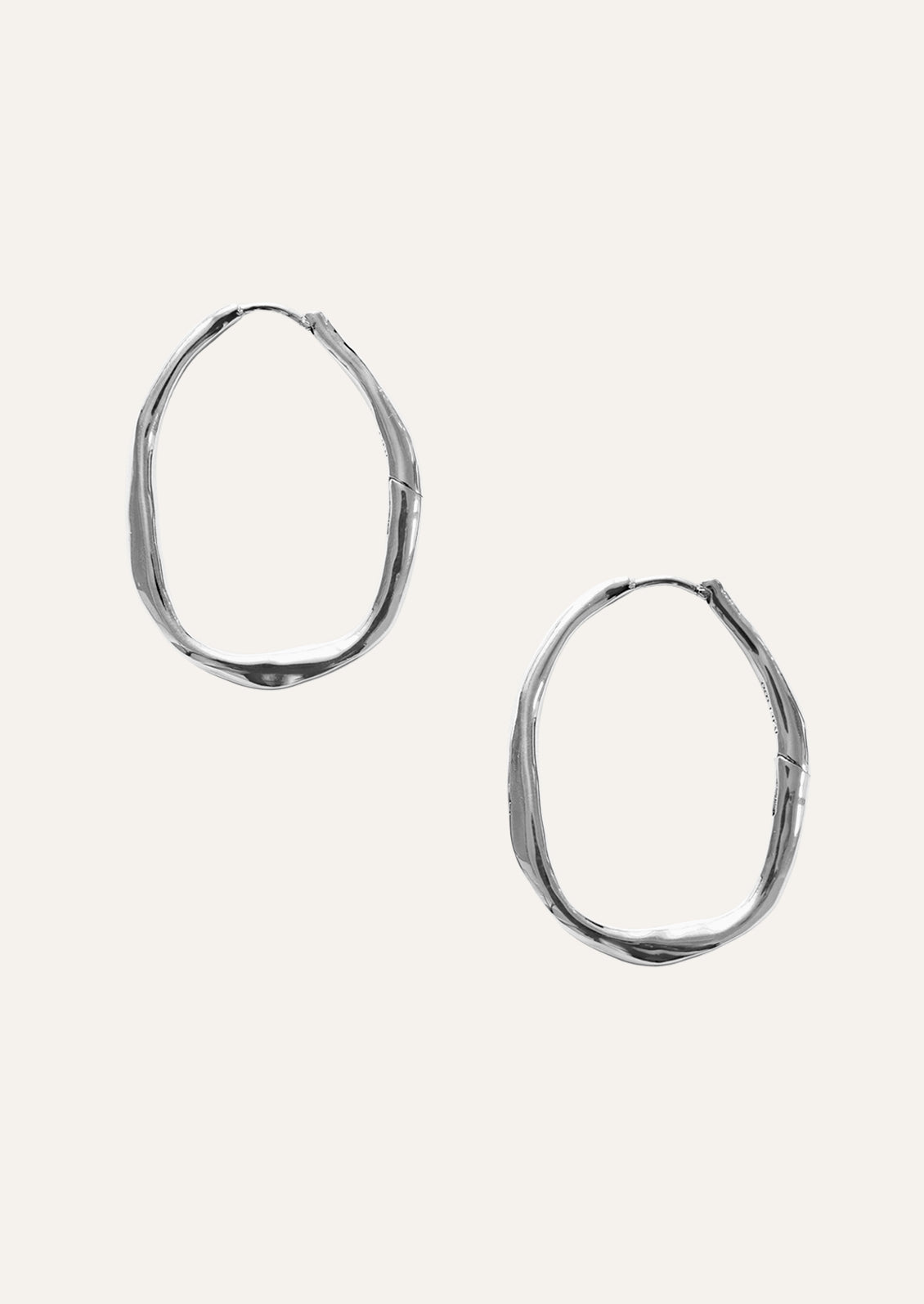 A pair of large sterling silver hoop earrings.