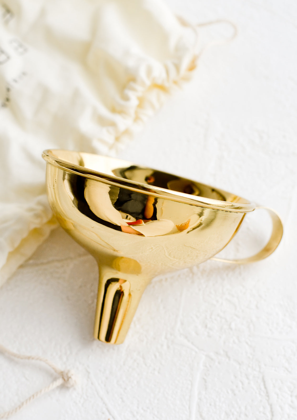 A shiny brass funnel.
