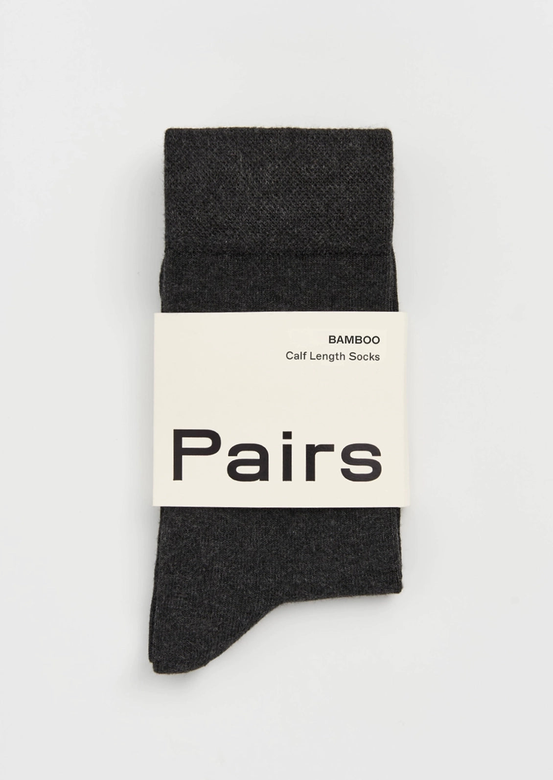 A pair of dark charcoal gray bamboo calf length socks folded vertically with a white paper band label that reads 'BAMBOO Calf Length Socks' and 'Pairs'.