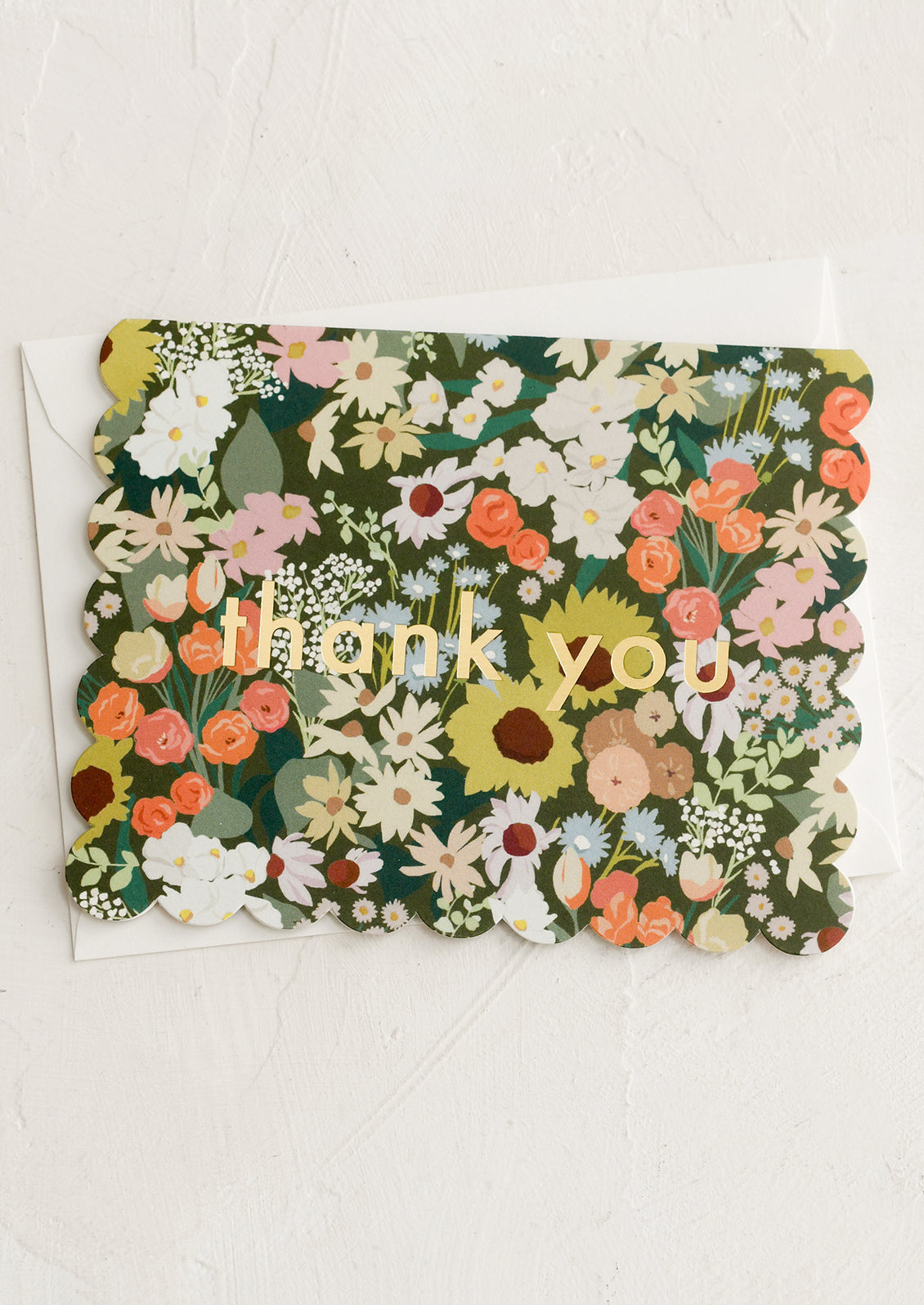 A floral print thank you card with scalloped edges.