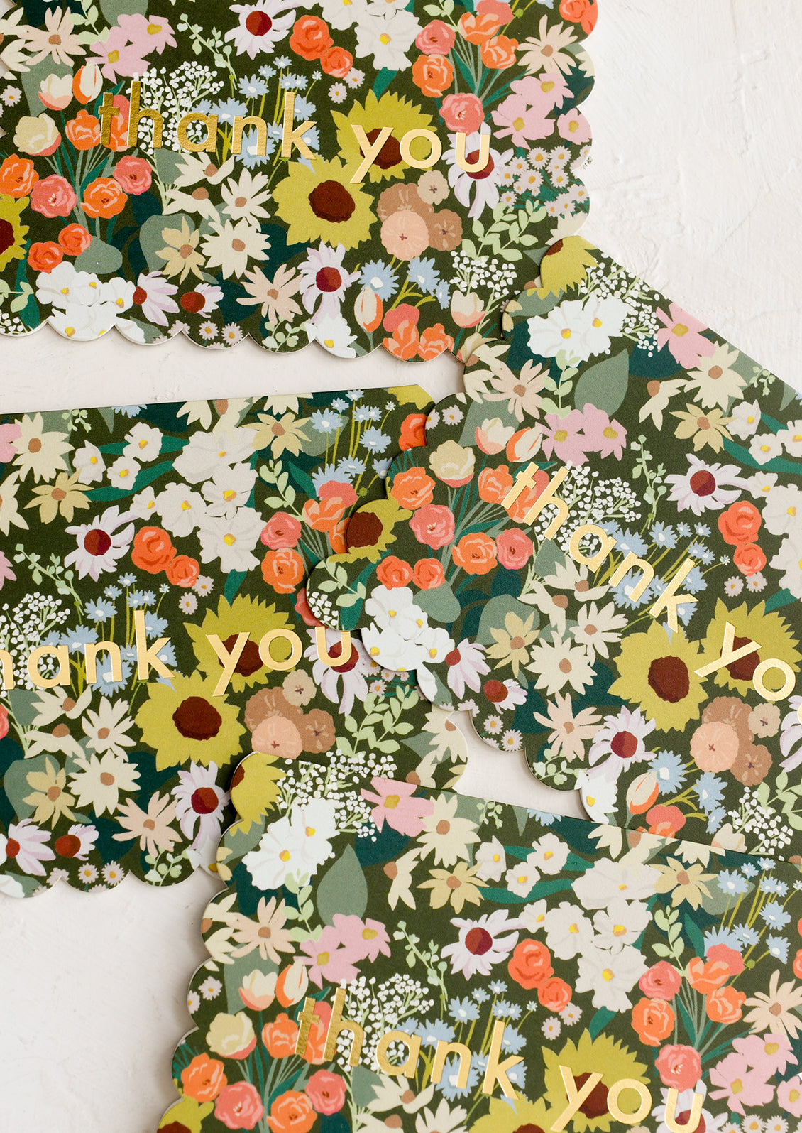A floral print thank you card set with scalloped edges.