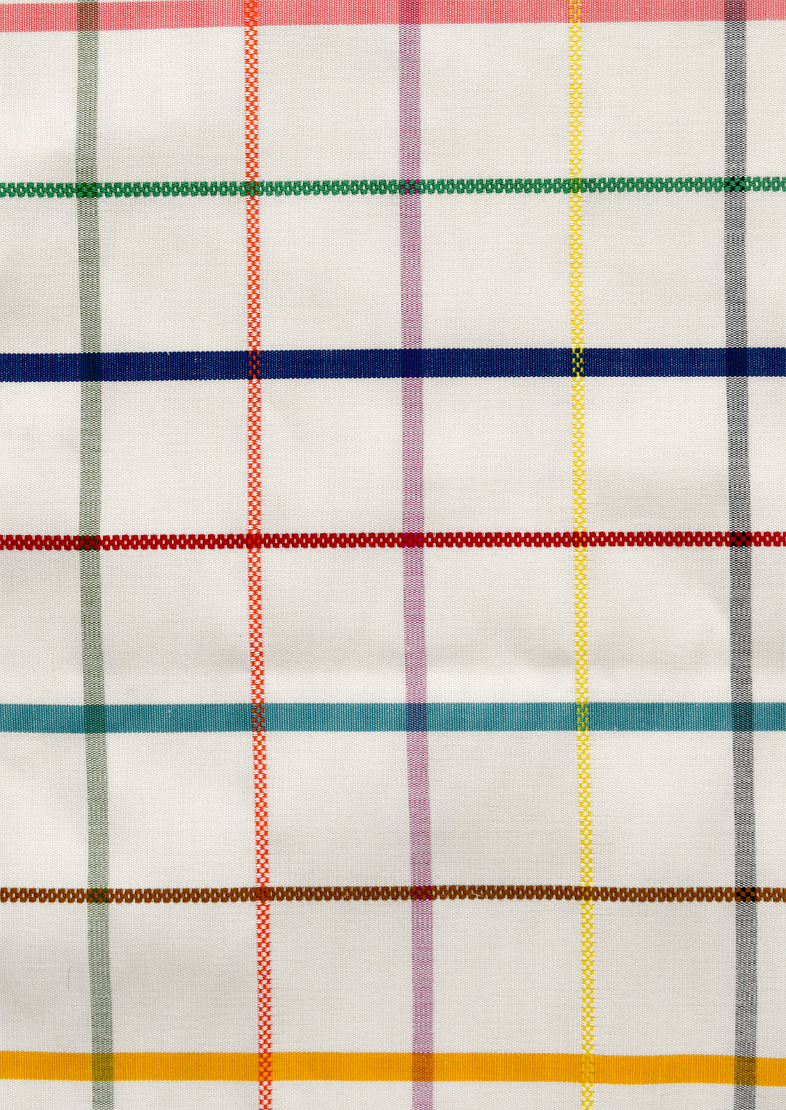 A close-up of a white fabric with a multicolor plaid pattern, featuring vertical and horizontal stripes in red, green, blue, yellow, purple, brown, and gray.