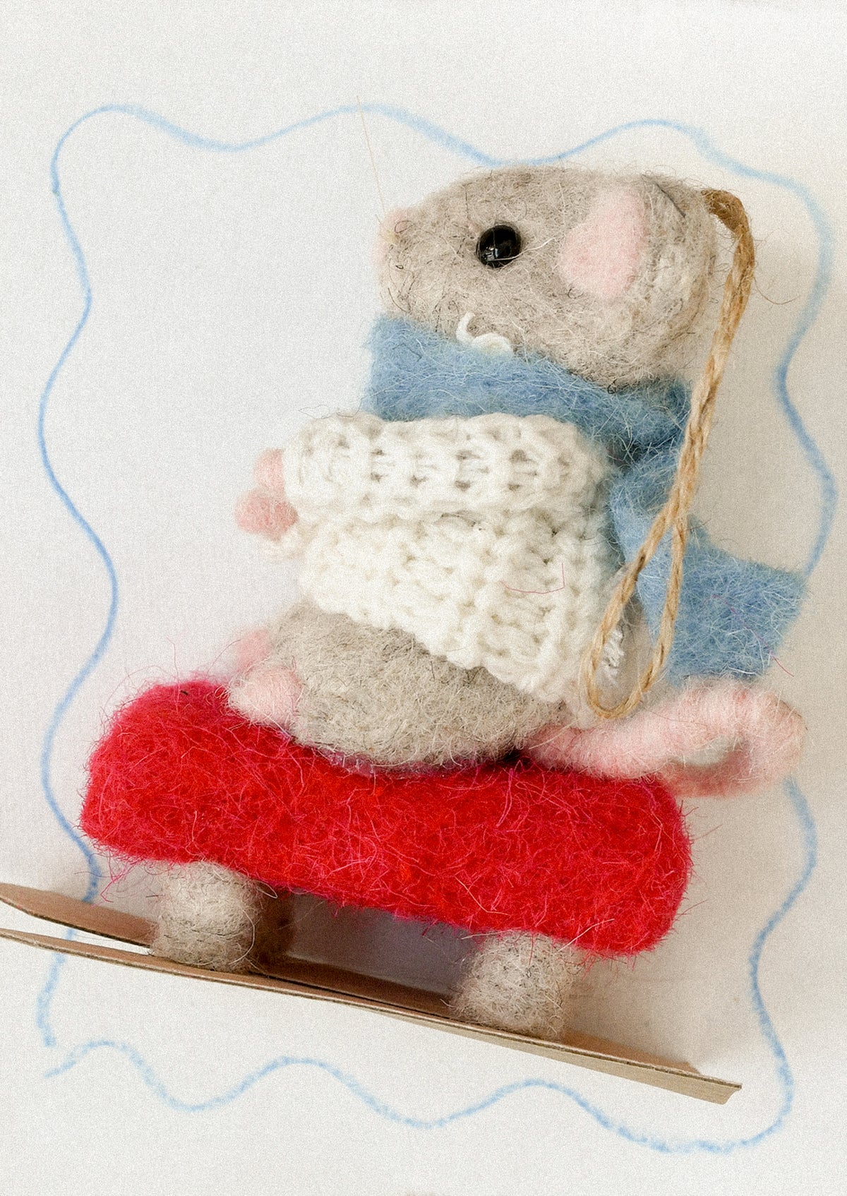 A decorative ornament of a mouse on skis.