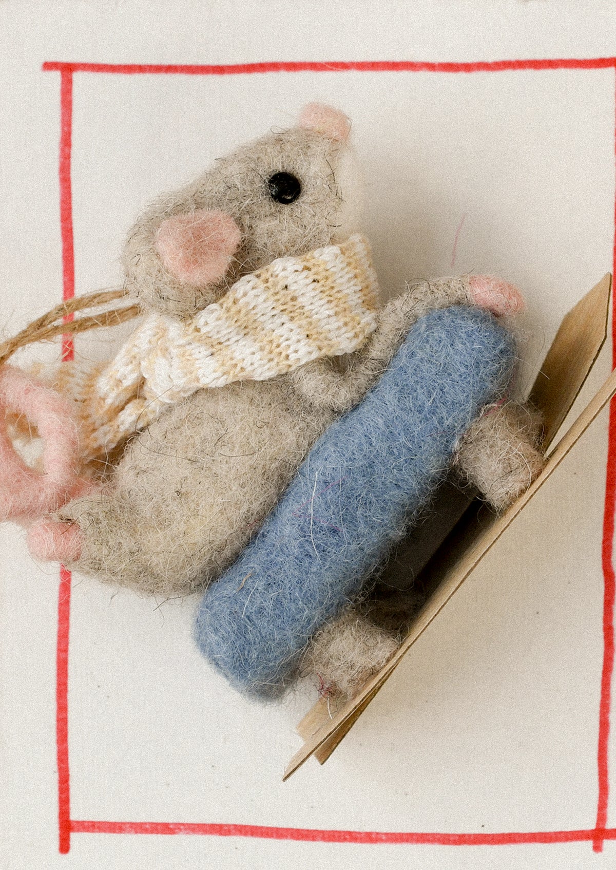 A decorative ornament of a mouse on skis.