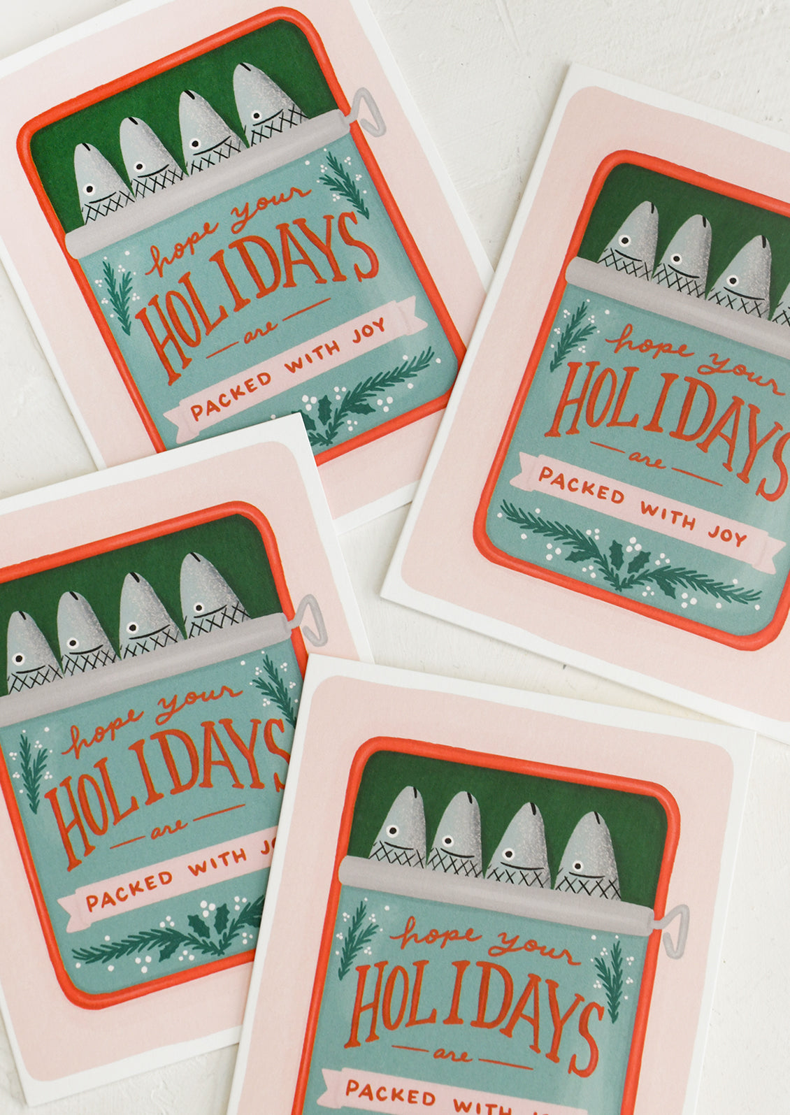 A set of cards with sardine tin illustration, text reads "Hope your holidays are packed with joy".