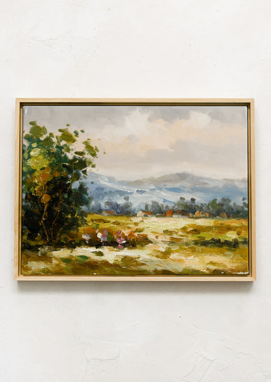 A framed original oil painting of countryside landscape.