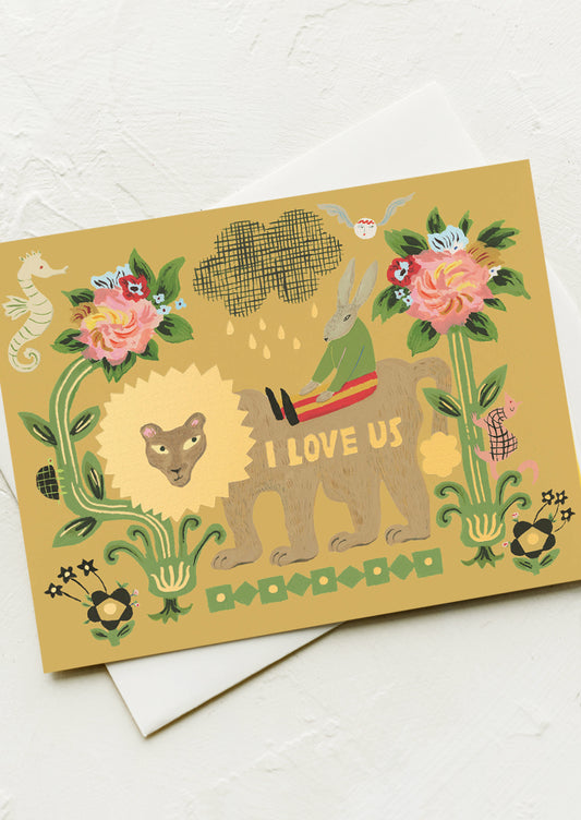 A card with whimsical illustration of rabbit and lion, text reads "I love us".
