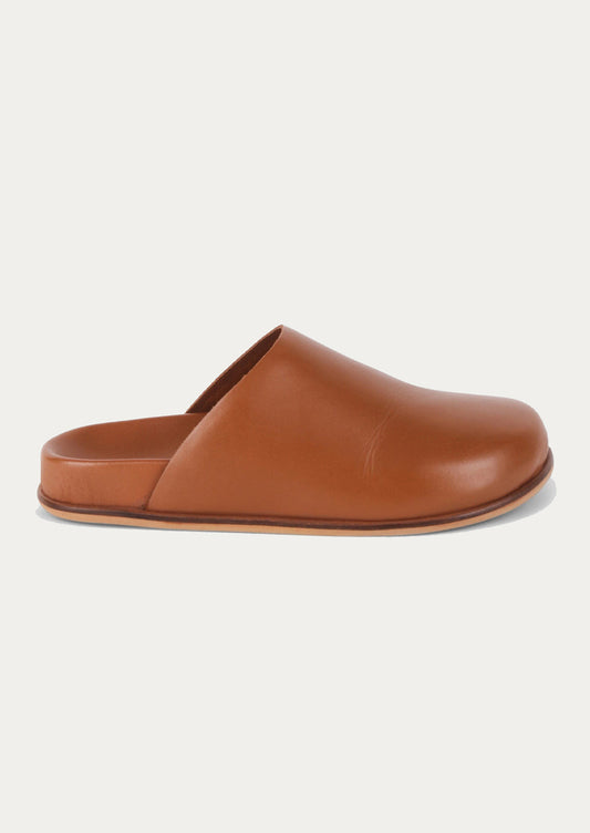A pair of caramel leather closed toe slip-on mule shoes.
