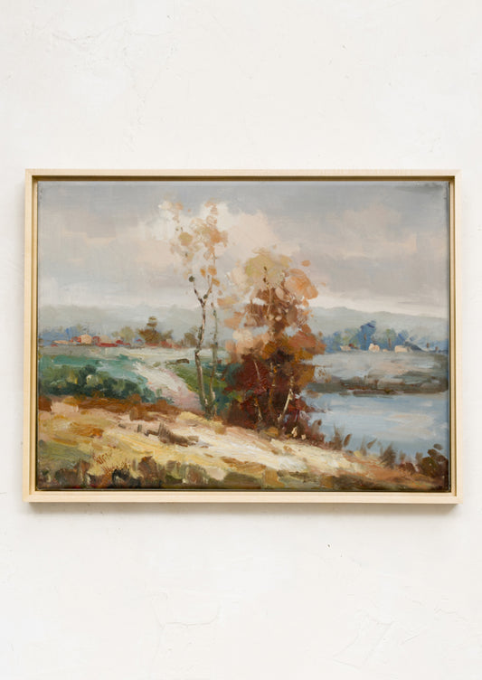 A framed landscape oil painting.