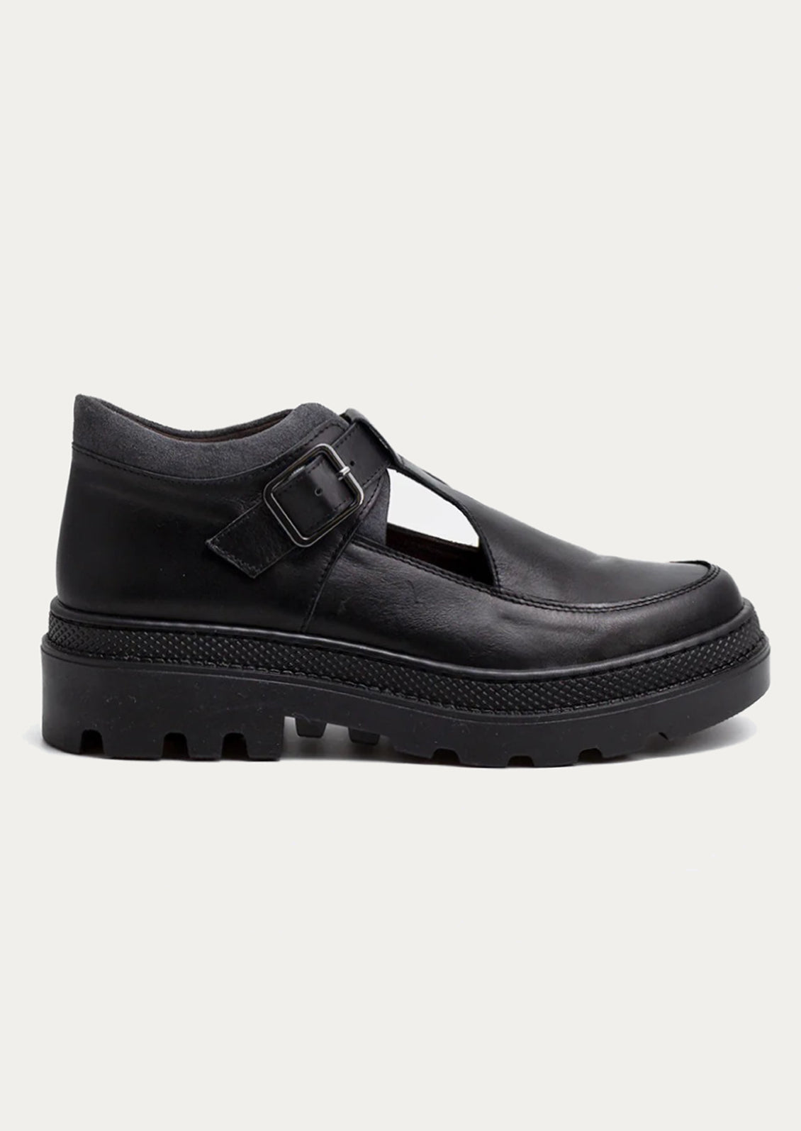 Black leather shoe with a strap and buckle on a white background