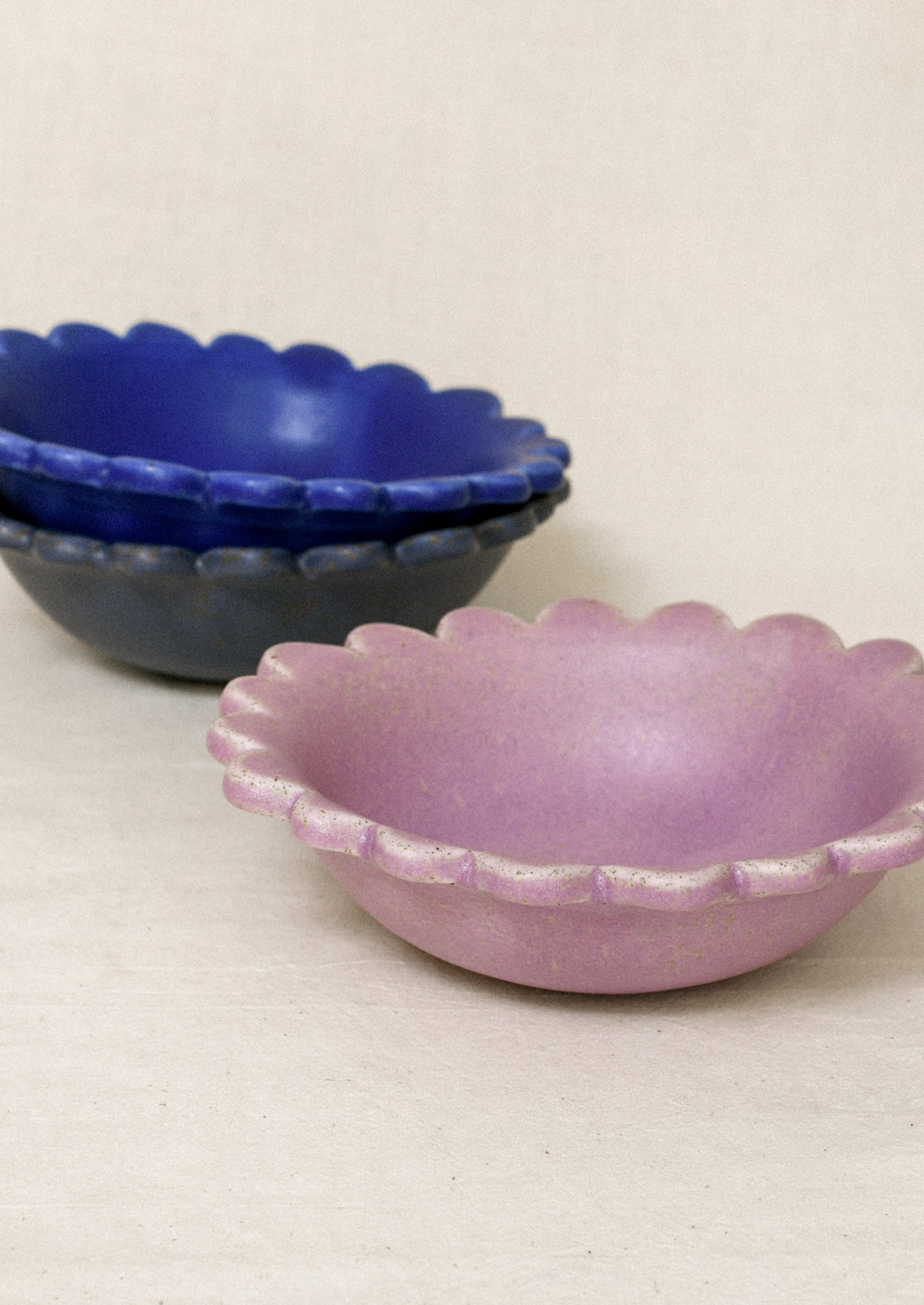 Ceramic scalloped edge bowls in a variety of colors.