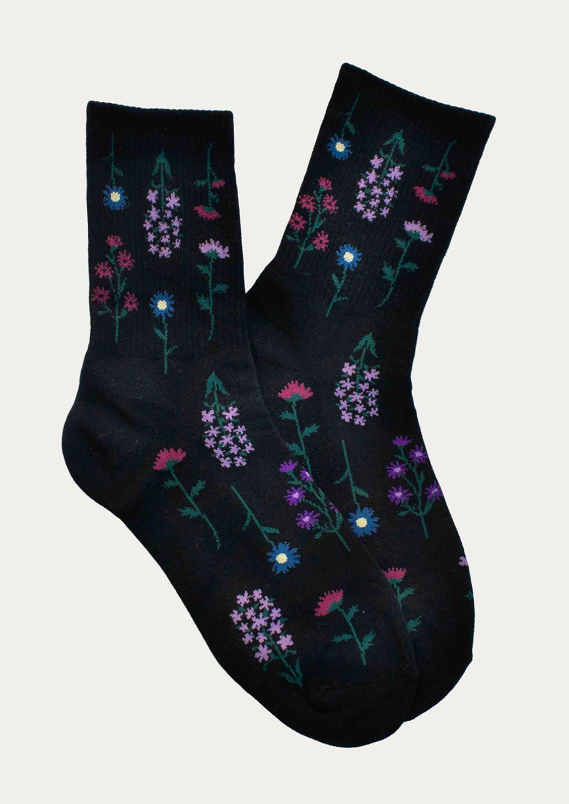 A pair of black socks with blue and pink flower pattern.