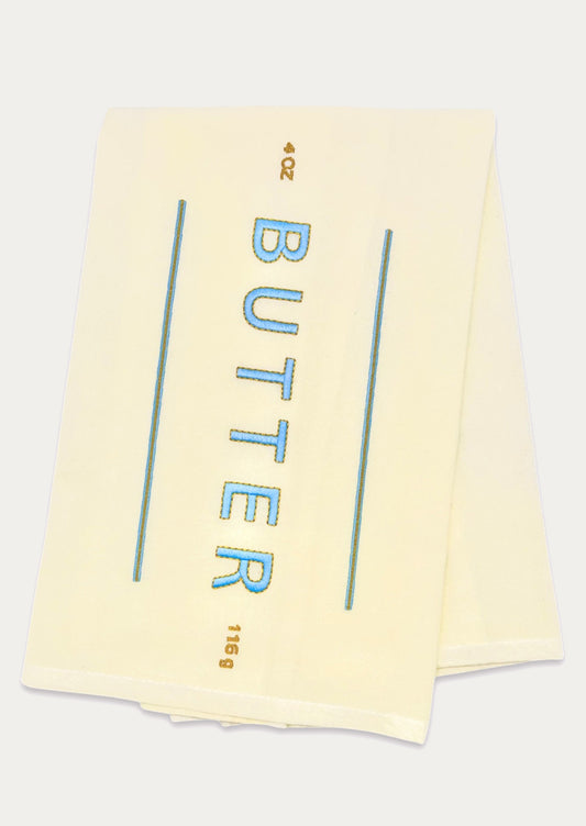 A yellow tea towel resembling a stick of butter.