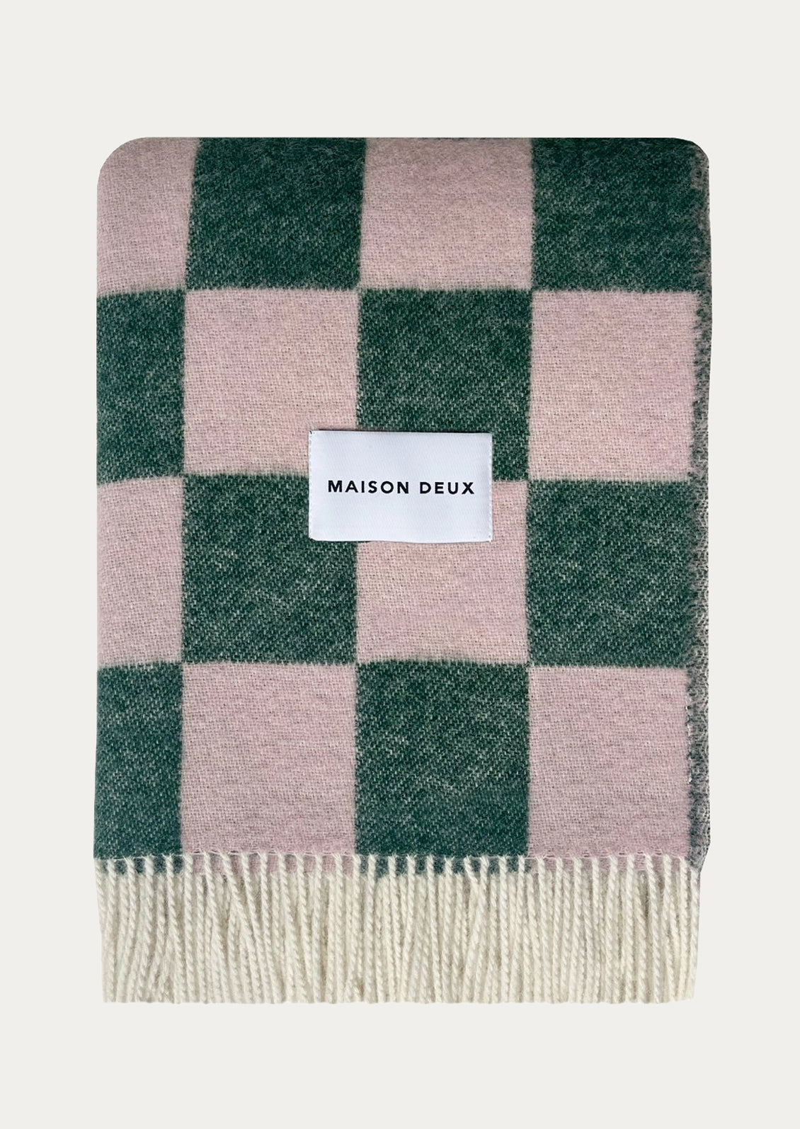A throw blanket in green and pink checker pattern.