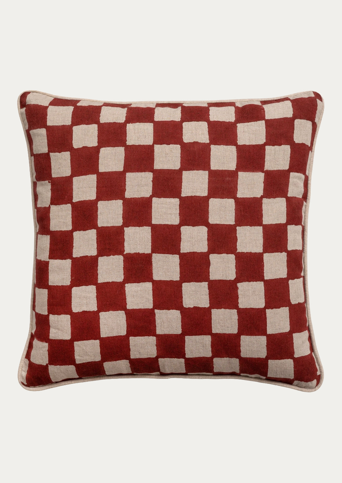 A square throw pillow featuring a red and beige checkered pattern, shown against a plain light gray background.