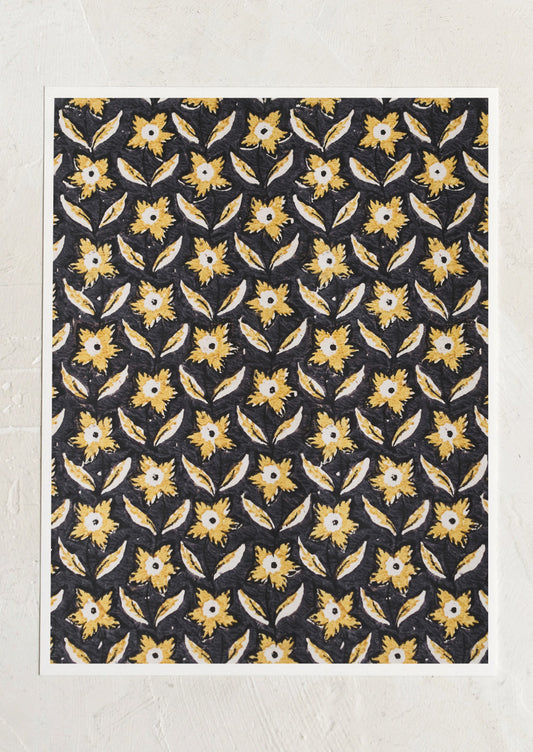 A block print textile inspired art print with black background and marigold colored flowers.