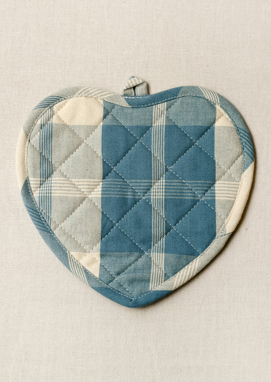 A heart shaped pot holder with a blue gingham pattern.