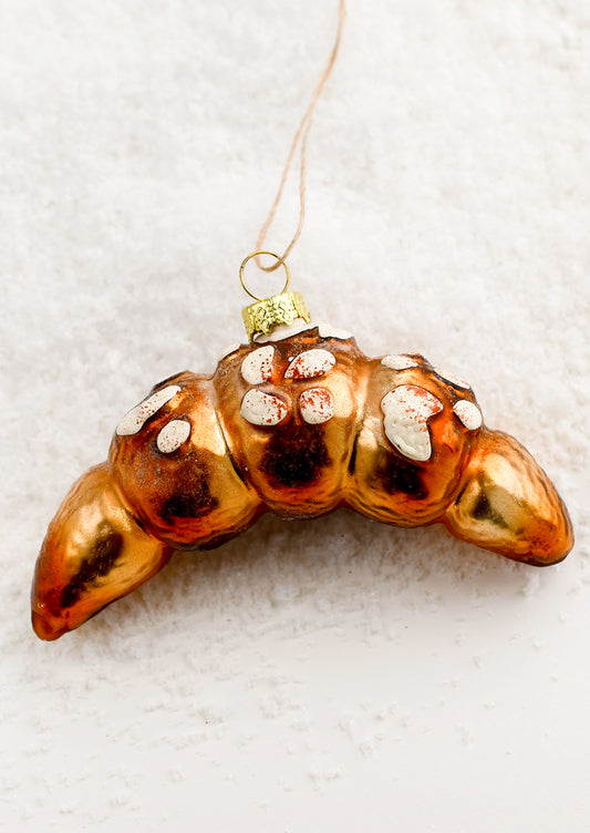 A holiday ornament of almond croissant.