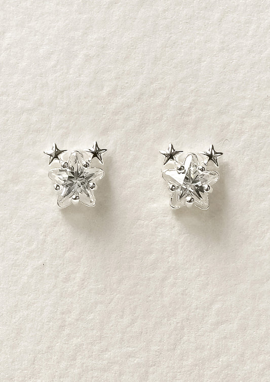 A pair of sterling silver star shaped cubic zirconia earrings with two tiny stars on the tops of each earring.