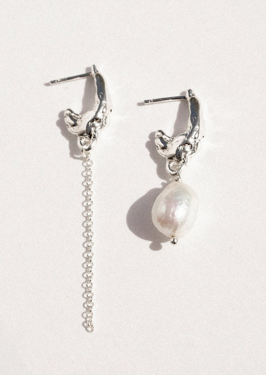 A pair of mismatched sterling silver earrings with a freshwater pearl.