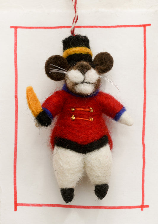A felted wool ornament of mouse in drum major costume.