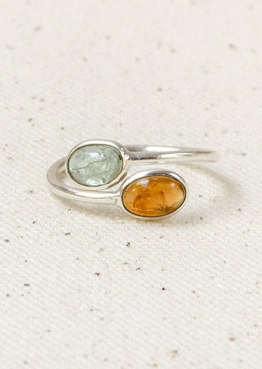 A sterling silver ring with a wrapped design and  two stacked natural tourmaline stones.