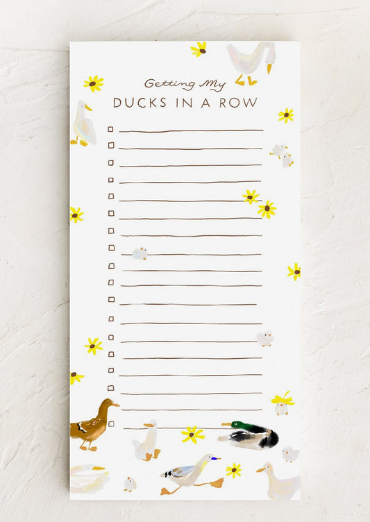 A long notepad with ruled lines and checkboxes, allover duck and flower print.
