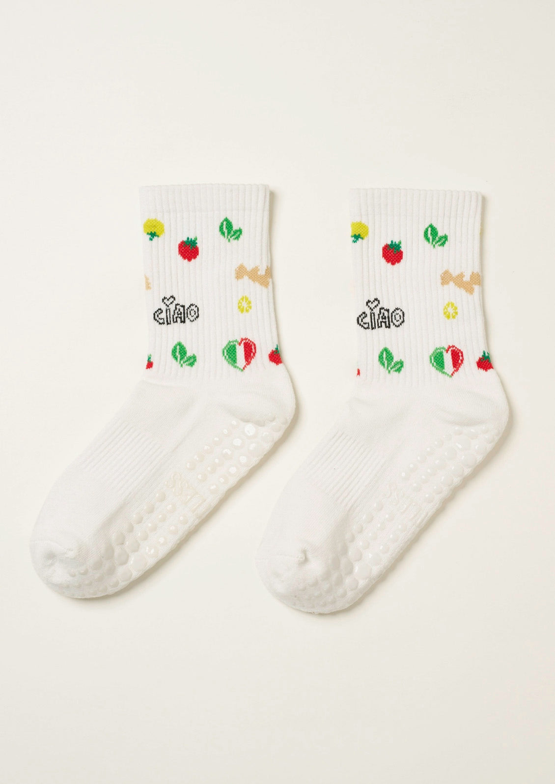 A pair of ribbed white socks with fun Italian-inspired illustrations embroidered on them and grips at the bottom to prevent slipping.