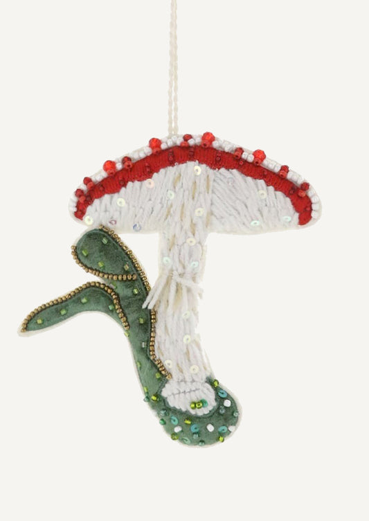 A fabric ornament embroidered in the image of red capped mushroom.