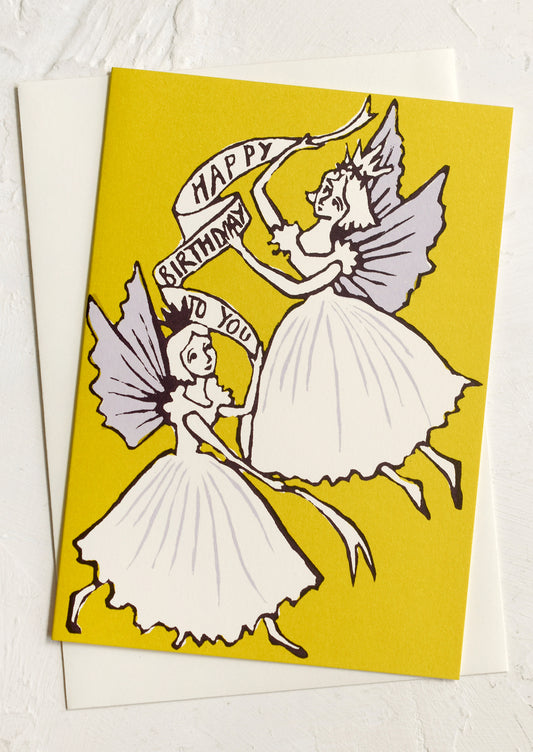 A greeting card with image of fairies holding "Happy Birthday To You" banner.