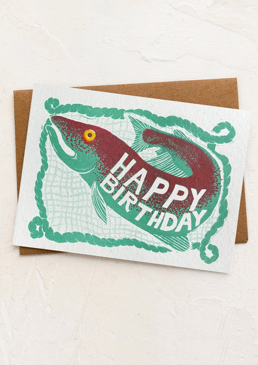 A birthday card with illustration of fish in net.