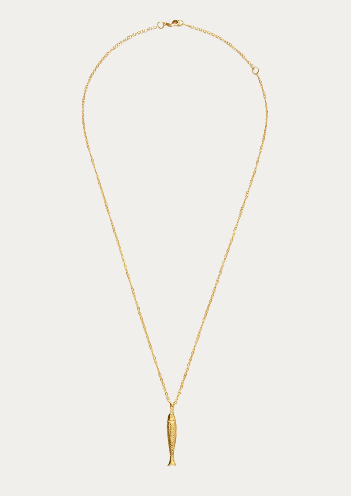 A gold chain necklace with a fish charm.