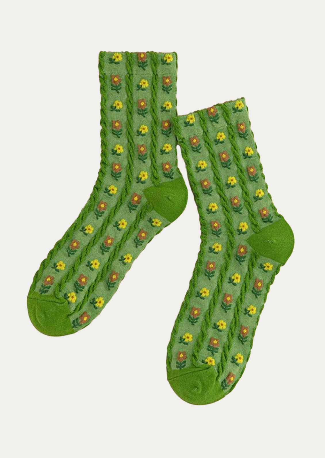A pair of green crew socks with small brown and yellow flowers throughout.