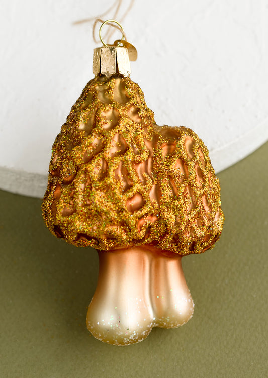 A glass holiday ornament of morels mushrooms.