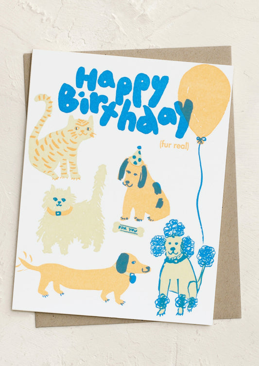 A card with illustration of cats and dogs, text reads "Happy birthday fur real".