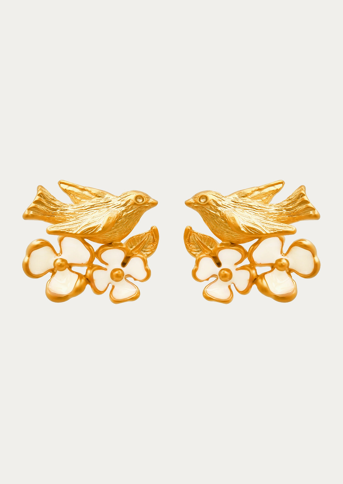 A pair of gold earrings adorned with a goldcrest bird and flowers.