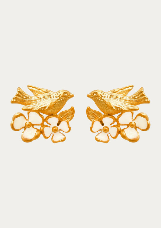 A pair of gold earrings adorned with a goldcrest bird and flowers.