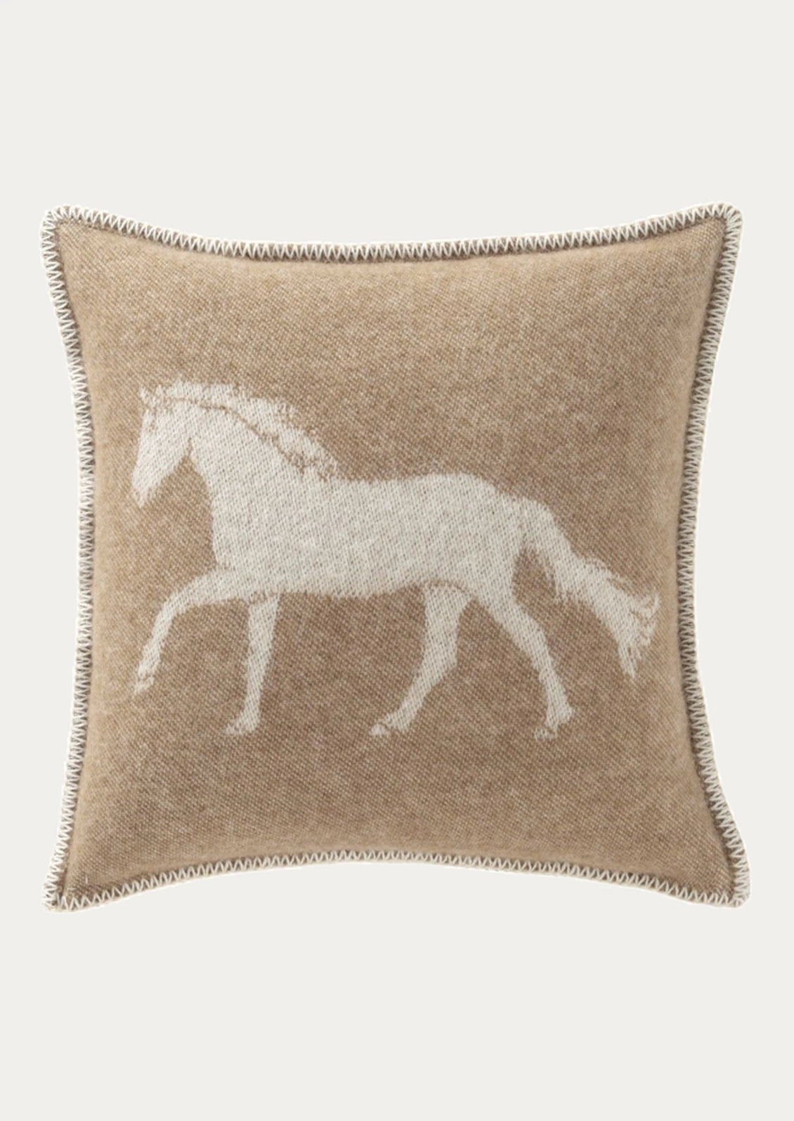 A square beige throw pillow with a white woven silhouette of a horse on the front, finished with a decorative braided border, shown against a light gray background.