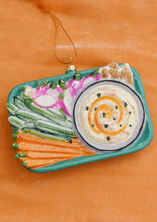 A glass ornament of a platter of hummus and vegetable crudites.