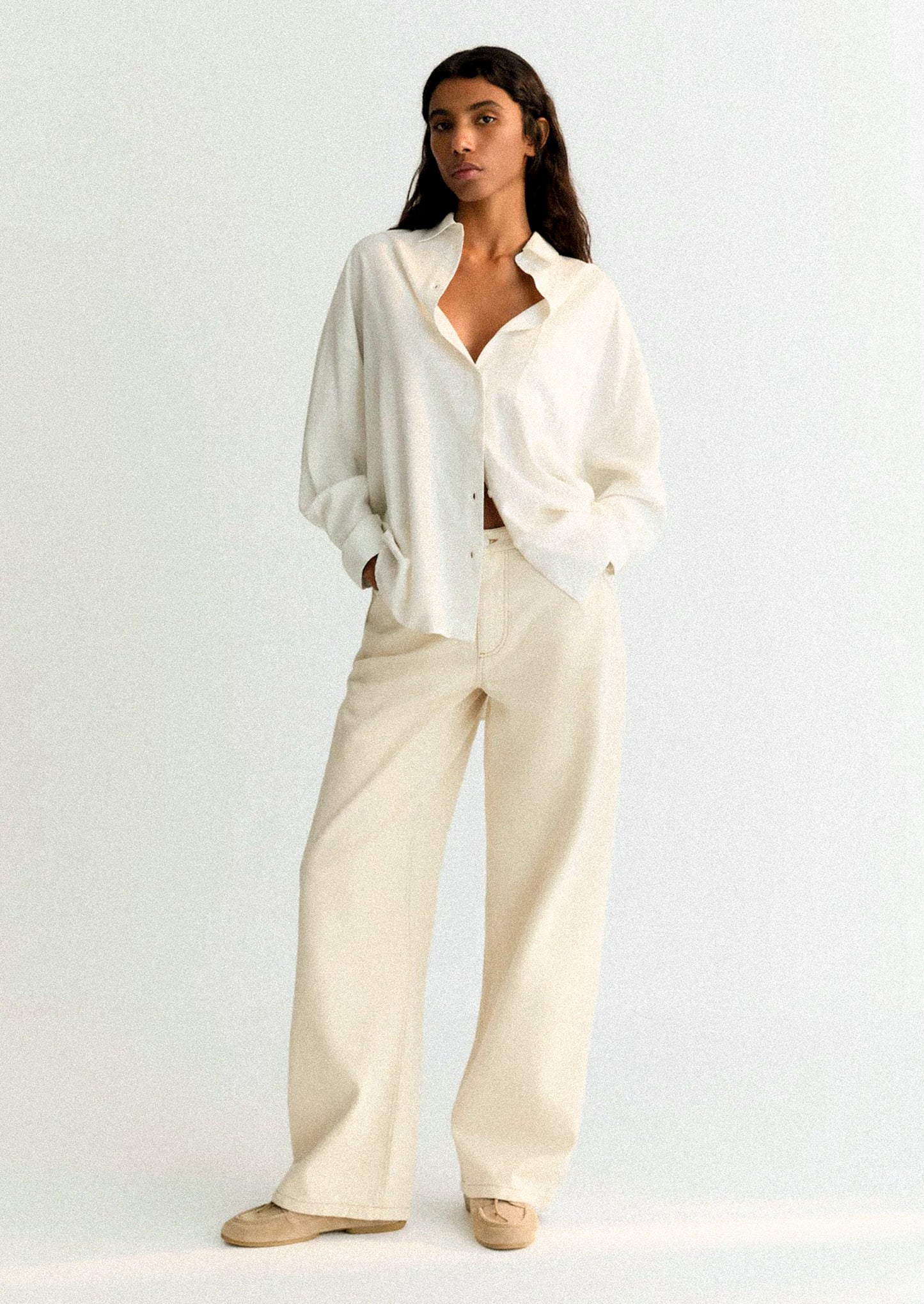 A person wearing a white button front shirt.