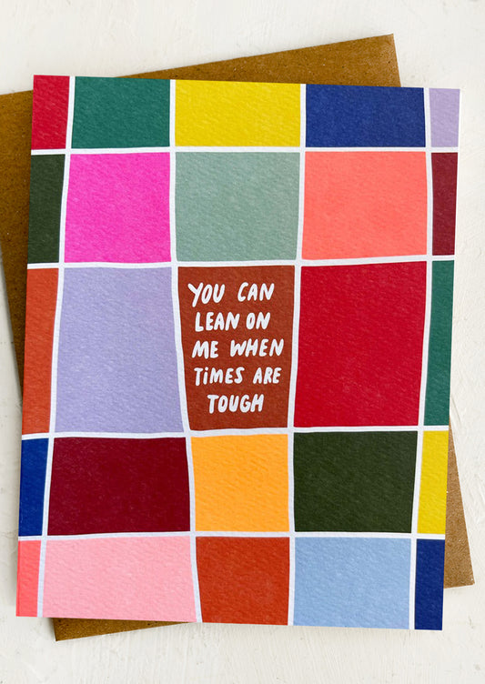 Colorful checkered card with motivational message on a white background