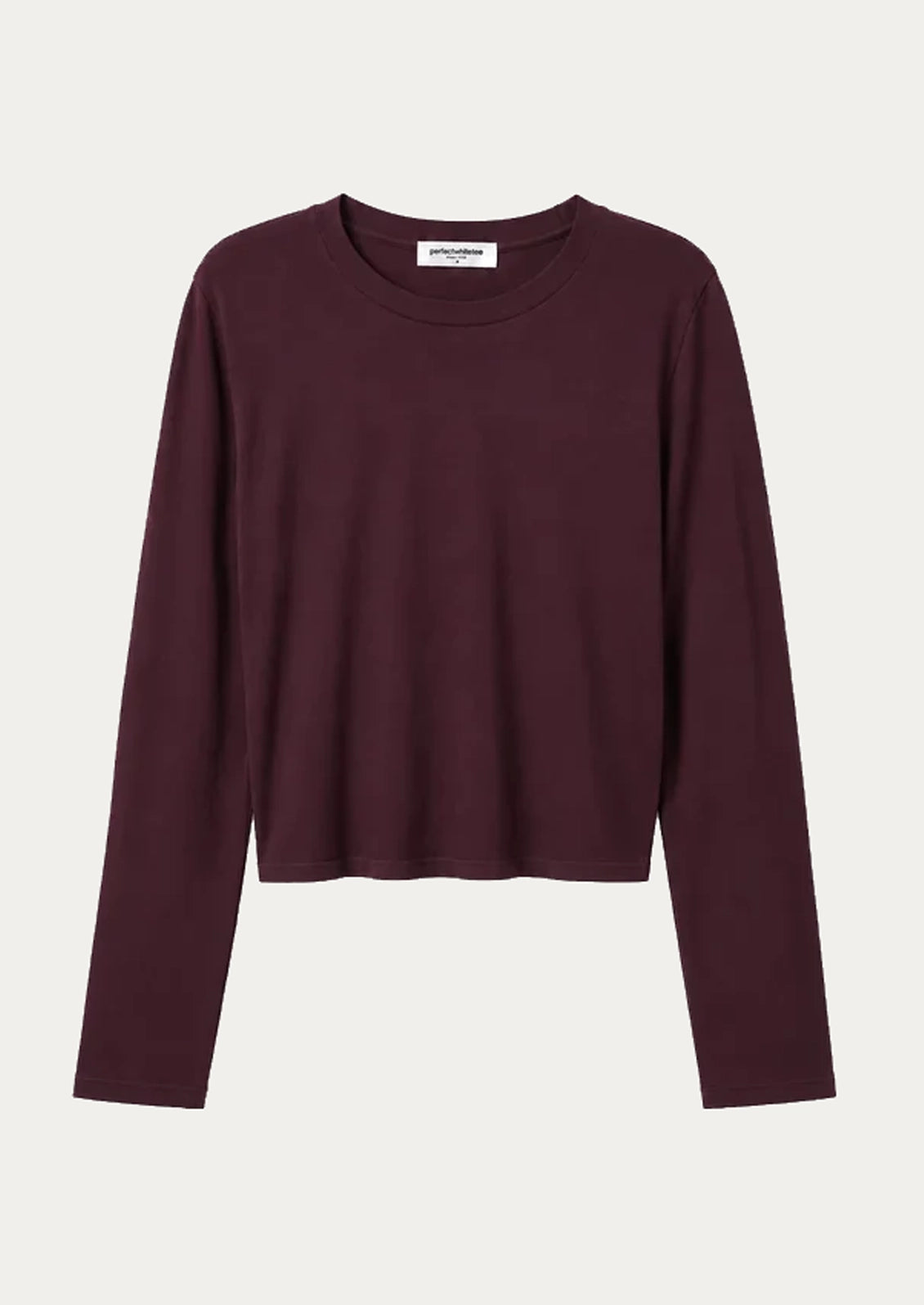 A dark burgundy long-sleeve crop top with a crew neck, displayed flat against a light off-white background.