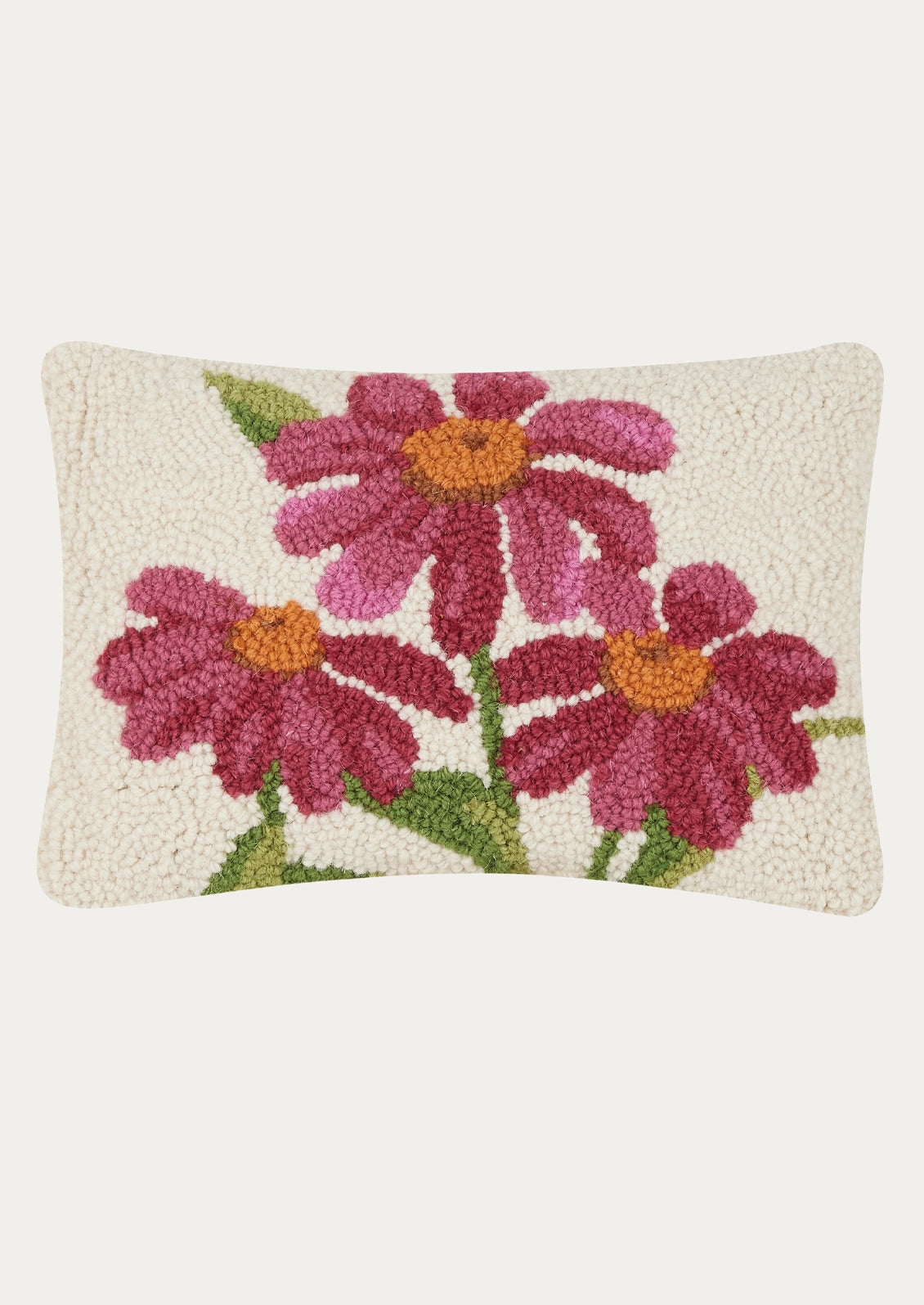 A rectangular hand-tufted decorative pillow with a textured cream background featuring three pink and magenta daisy flowers with yellow-orange centers and green stems.
