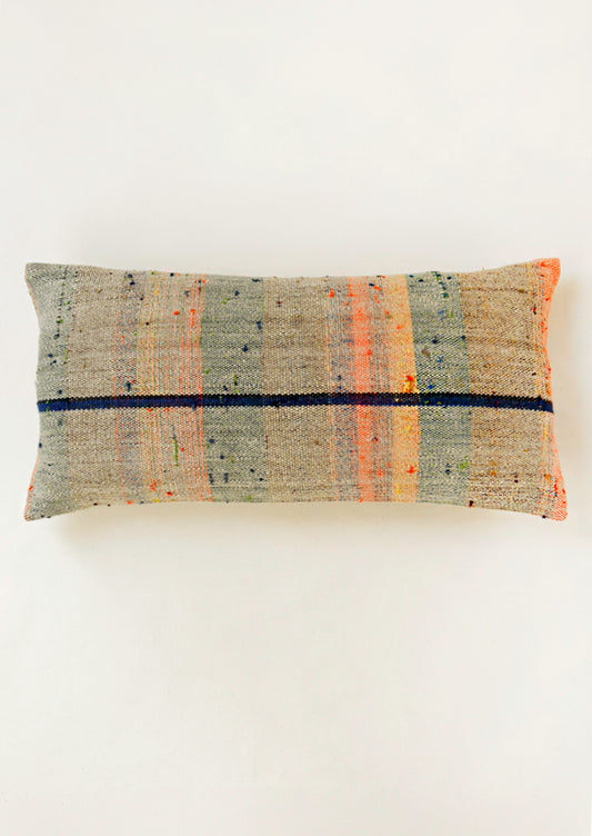 A rectangular 12" x 24" mottled kilim pillow with various colored striped throughout.