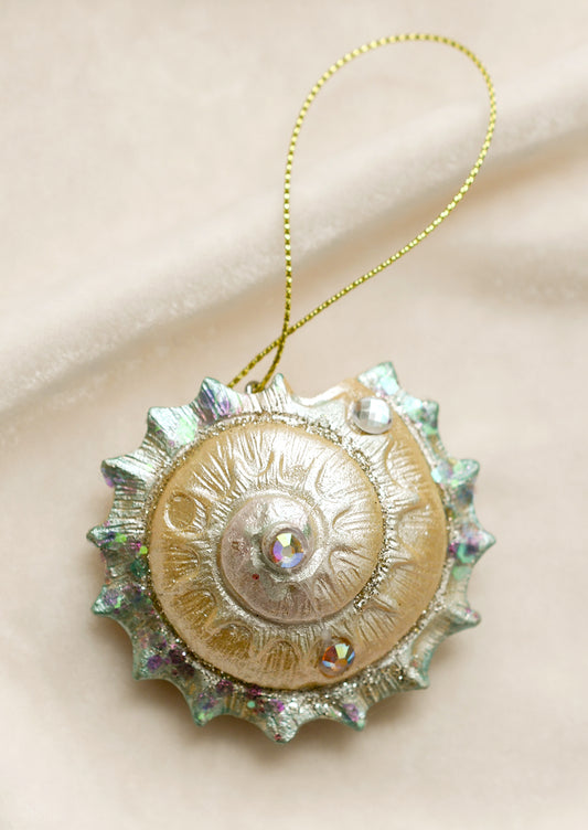 A nautilus shell ornament with pearlescent finish.