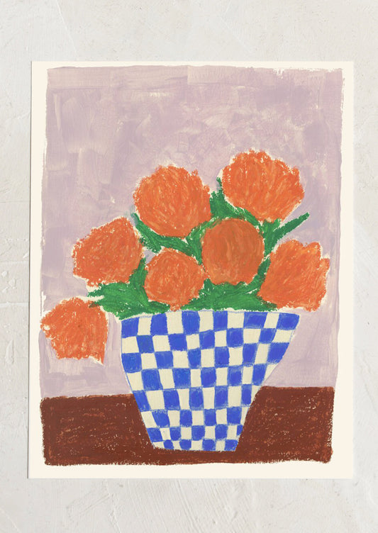 An art print of a painting of orange flowers in a blue and white checkered vase.