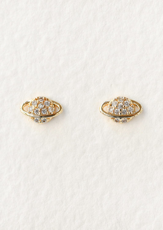 A pair of gold planet shaped stud earrings with cubic zirconia gems in the center.