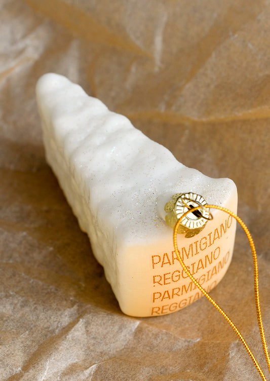 A glass ornament designed to look like a wedge of parmesan cheese.